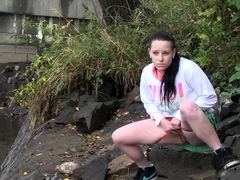 Raven Haired Girl Pees Near The River