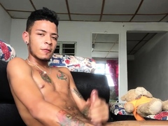 Inked Latin twink strokes his pecker